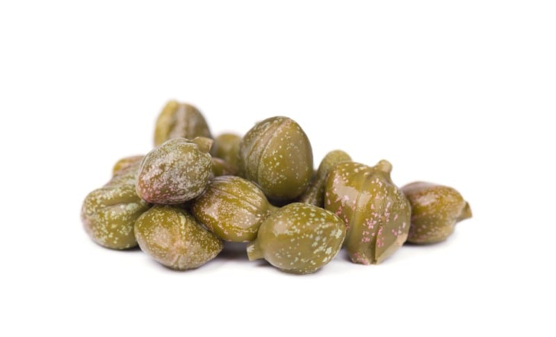 Marinated capers on a white background