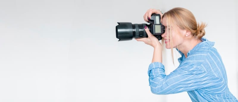 Female Photographer shooting with camera