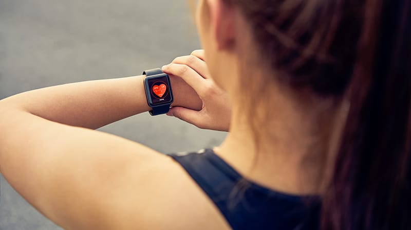Woman checking her smartwatch for health updates